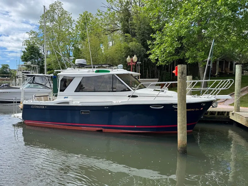 Slide: The Image of 2016 Cutwater C-26 boat docked in a serene marina setting. - 3