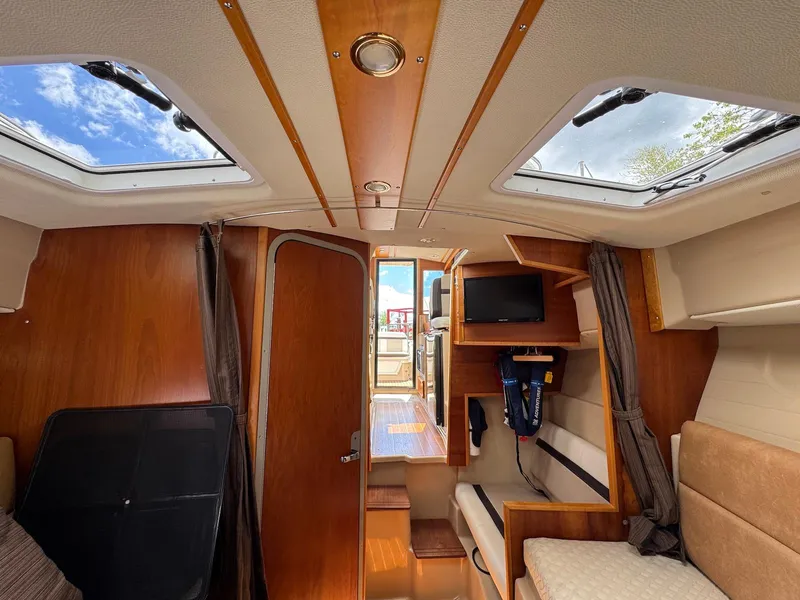 Slide: The Image of Interior of 2016 Cutwater C-26 boat with skylights, seating, and a small TV. - 34
