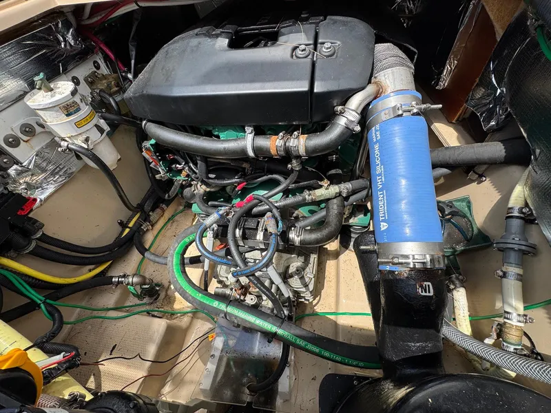 Slide: The Image of Engine compartment of a 2016 Cutwater C-26 boat, showcasing various hoses and components. - 36