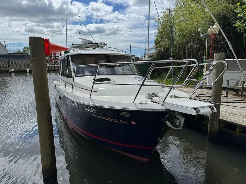 Slide: The Image of 2016 Cutwater C-26 boat docked in a marina, under a cloudy sky. - 5