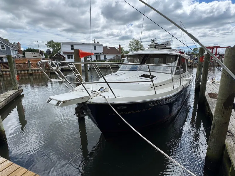 Slide: The Image of 2016 Cutwater C-26 boat docked in a marina under cloudy skies. - 6