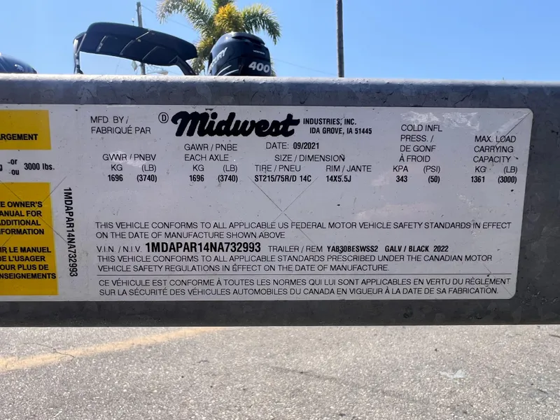 Slide: The Image of Trailer label with specifications, including GVWR, tire size, and VIN, manufactured by Midwest Industries in 2022. - 14