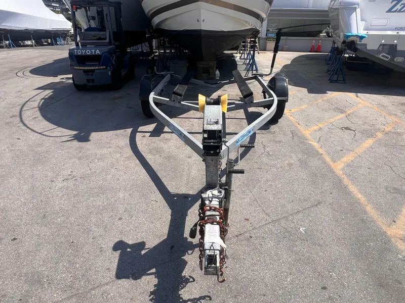 Slide: The Image of Boat trailer model 19 from 2022 parked in a marina. - 3