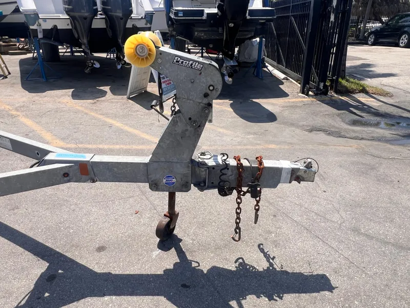 Slide: The Image of Trailer hitch with chains and wheel, 2022 model, parked on concrete. - 9