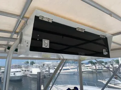 Slide: The Image of 1989 Trojan 12 Meter Convertible boat with overhead storage, docked at a marina. - 10