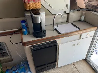 Slide: The Image of Compact kitchenette in 1989 Trojan 12 Meter Convertible boat with coffee maker and sink. - 33