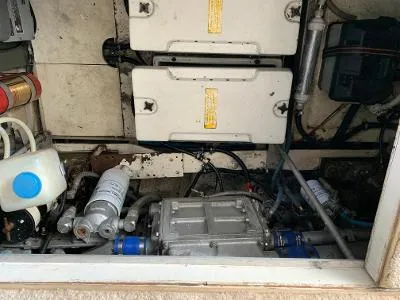 Slide: The Image of Engine compartment of a 1989 Trojan 12 Meter Convertible boat, showing mechanical components. - 34