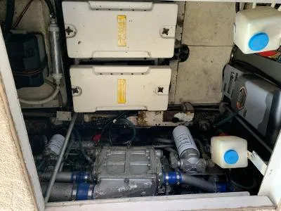 Slide: The Image of Engine compartment of a 1989 Trojan 12 Meter Convertible boat, showing mechanical components. - 35