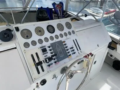 Slide: The Image of Control panel of a 1989 Trojan 12 Meter Convertible boat with gauges and steering wheel. - 4