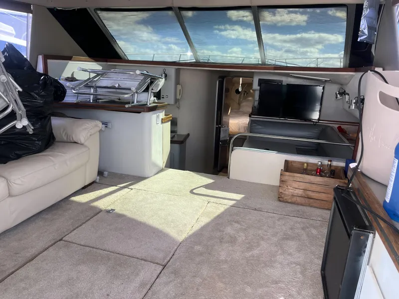 Slide: The Image of Interior of a 1989 Trojan 12 Meter Convertible yacht with seating and storage. - 40