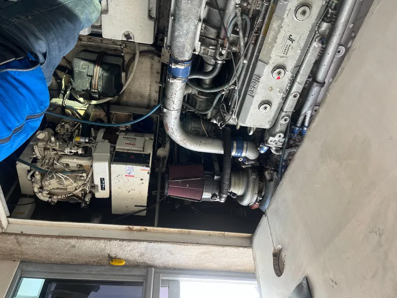 Slide: The Image of Engine compartment of a 1989 Trojan 12 Meter Convertible boat, showcasing mechanical components. - 47