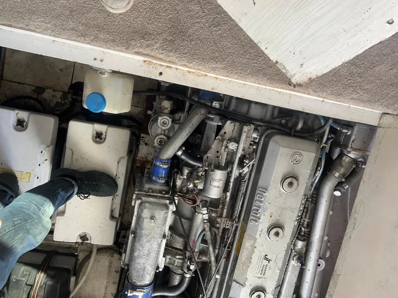 Slide: The Image of Engine compartment of a 1989 Trojan 12 Meter Convertible boat, showing mechanical components. - 48