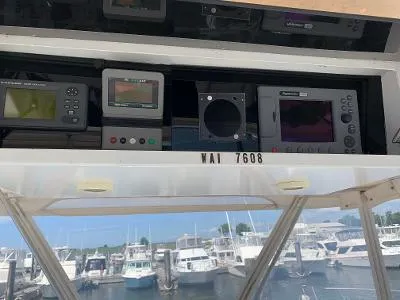 Slide: The Image of Control panel of a 1989 Trojan 12 Meter Convertible boat at a marina. - 14