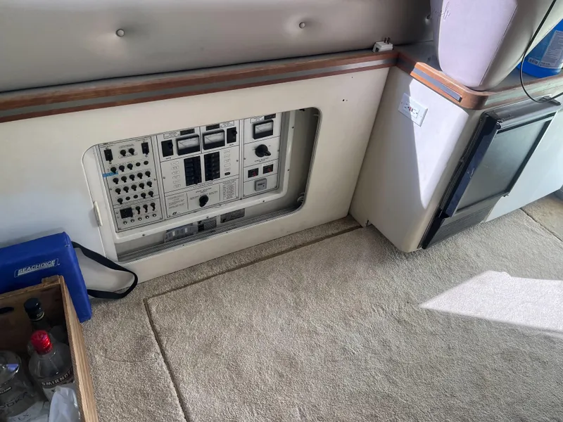 Slide: The Image of Control panel inside a 1989 Trojan 12 Meter Convertible yacht, featuring carpeted flooring. - 38