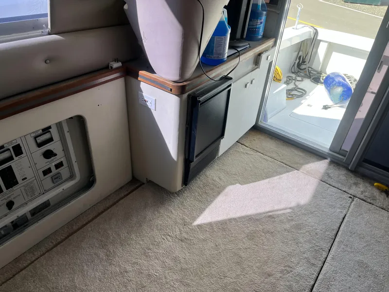 Slide: The Image of Interior of 1989 Trojan 12 Meter Convertible yacht with carpet and mini fridge. - 39