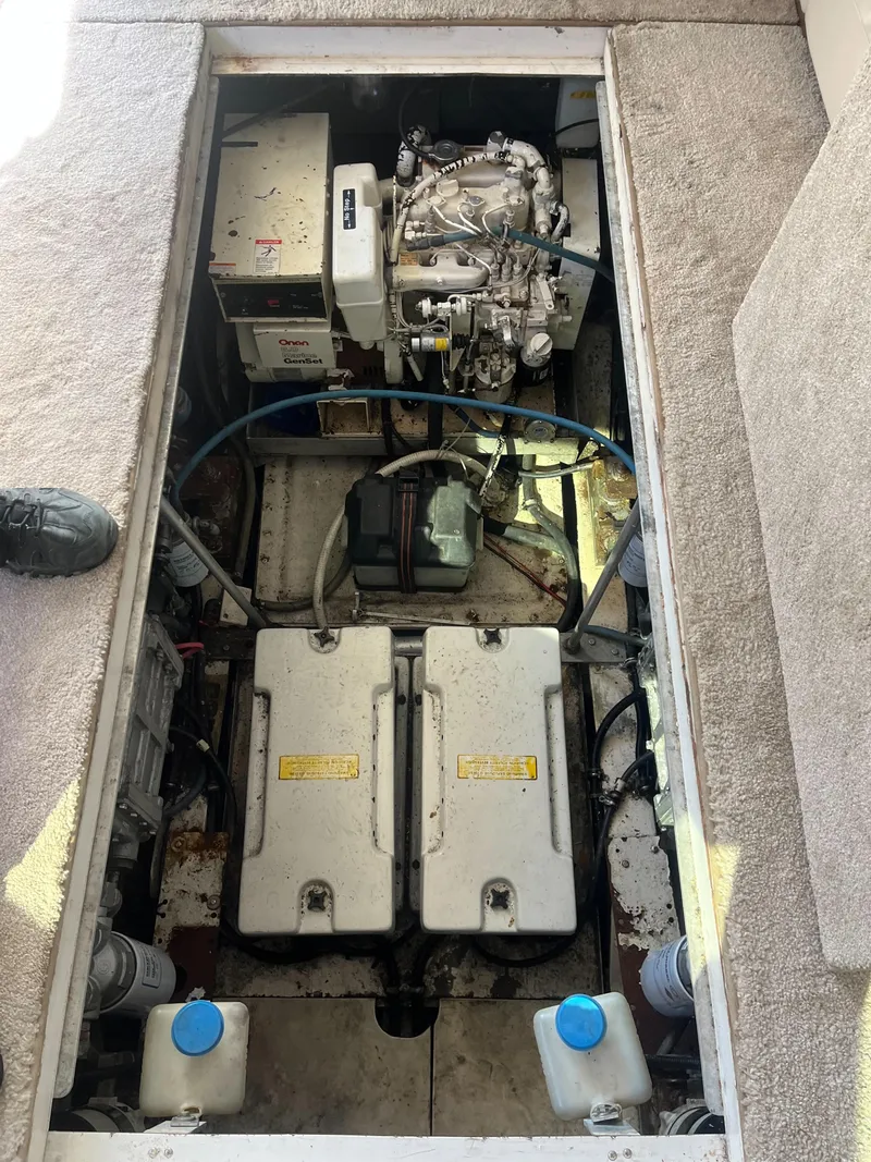 Slide: The Image of Engine compartment of a 1989 Trojan 12 Meter Convertible boat, showing machinery and components. - 41