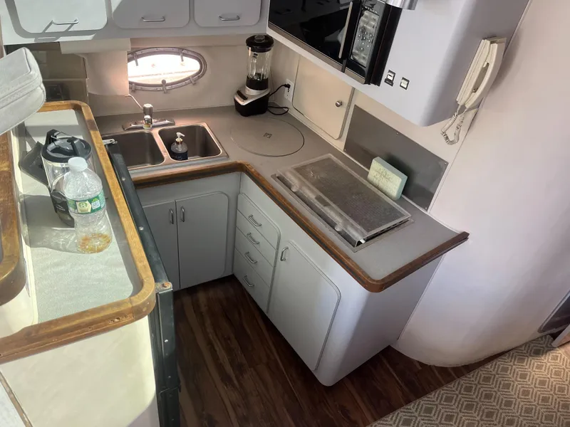 Slide: The Image of 1989 Trojan 12 Meter Convertible yacht kitchen with sink, blender, and wooden countertops. - 43