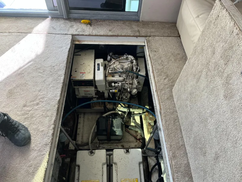 Slide: The Image of Engine compartment of a 1989 Trojan 12 Meter Convertible yacht, showing mechanical components. - 46