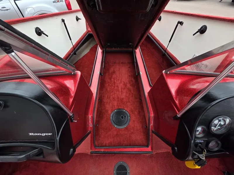 Slide: The Image of 1997 Ranger 692 boat interior with red carpet and storage compartments. - 11