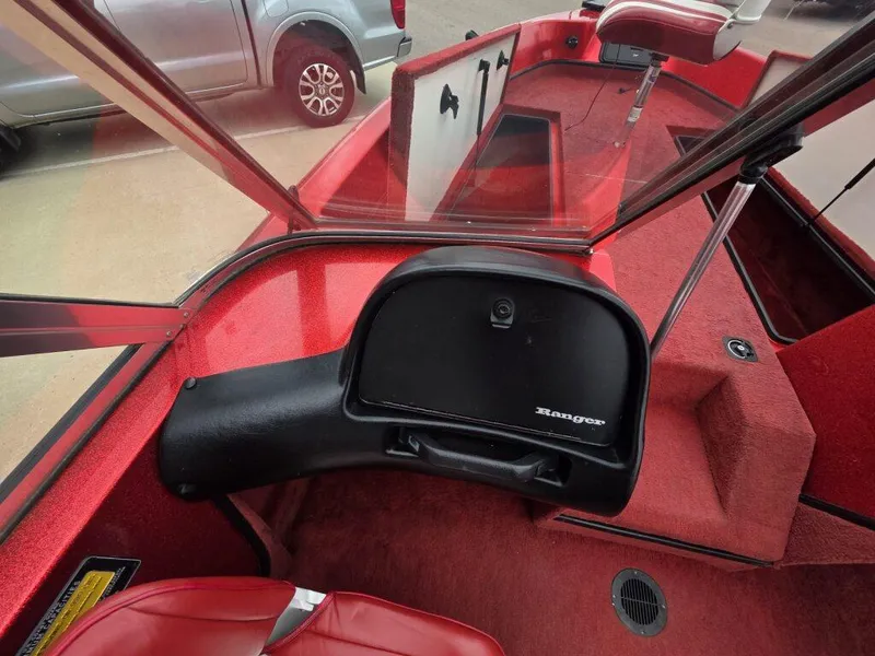 Slide: The Image of 1997 Ranger 692 boat interior with red upholstery and dashboard. - 12
