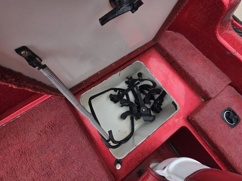 Slide: The Image of Storage compartment in a 1997 Ranger 692 boat with red carpet interior. - 16