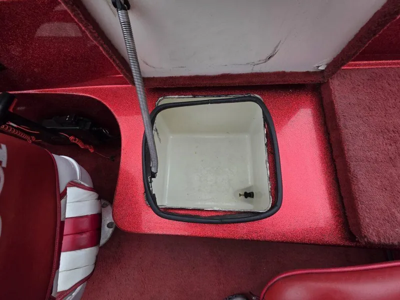 Slide: The Image of Red interior of 1997 Ranger 692 boat with open storage compartment. - 19