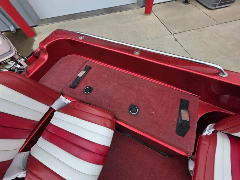 Slide: The Image of Red and white interior of a 1997 Ranger 692 boat with seating and storage. - 22