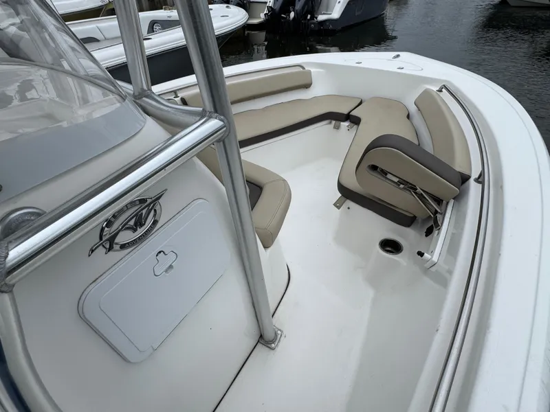 Slide: The Image of 2020 Tidewater 198 CC Adventure boat interior with cushioned seating and storage. - 13