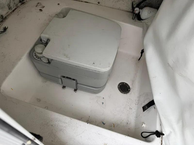 Slide: The Image of 2020 Tidewater 198 CC Adventure boat interior with portable toilet and drain. - 16