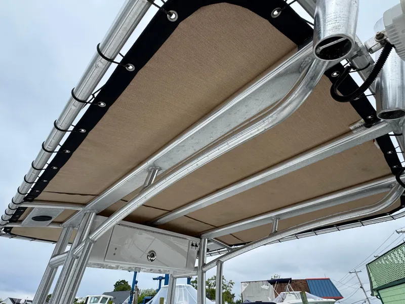 Slide: The Image of 2020 Tidewater 198 CC Adventure boat T-top with rod holders and canvas cover. - 6
