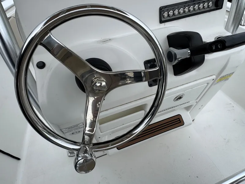 Slide: The Image of Steering wheel of 2020 Tidewater 198 CC Adventure boat, featuring sleek chrome design. - 9