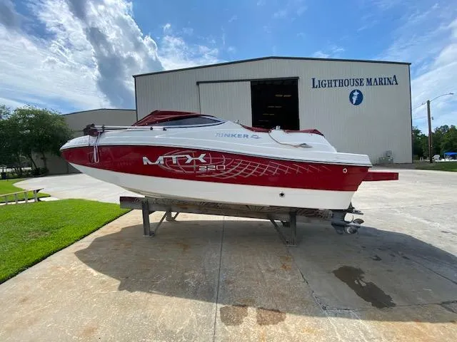 Slide: The Image of 2013 Rinker Captiva 220 MTX boat at Lighthouse Marina, red and white design. - 11