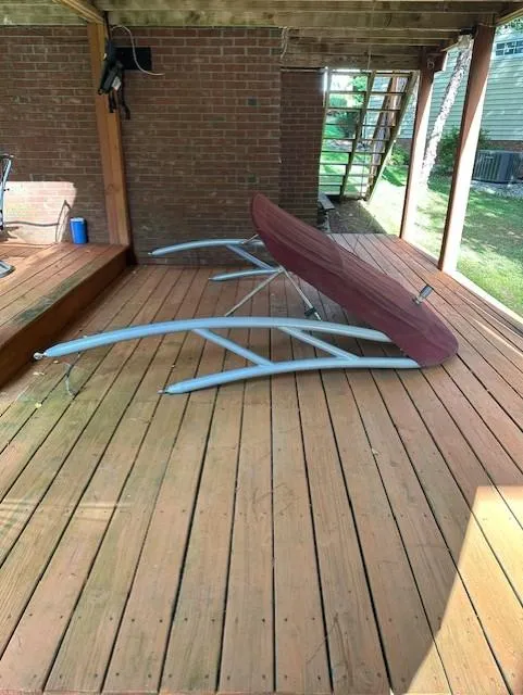 Slide: The Image of 2013 Rinker Captiva 220 MTX boat cover on wooden deck near brick wall. - 12