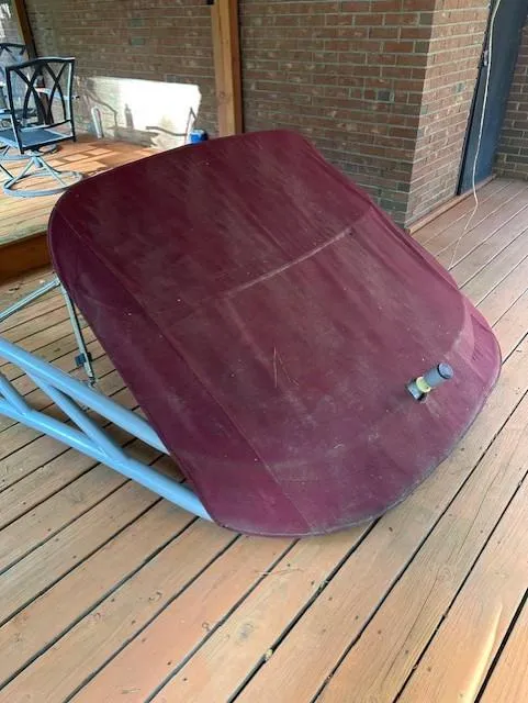 Slide: The Image of 2013 Rinker Captiva 220 MTX boat cover on wooden deck. - 14