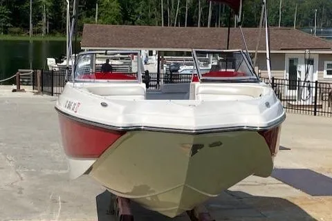 Slide: The Image of 2013 Rinker Captiva 220 MTX boat docked at a marina. - 16