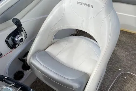 Slide: The Image of 2013 Rinker Captiva 220 MTX boat seat with steering controls. - 17