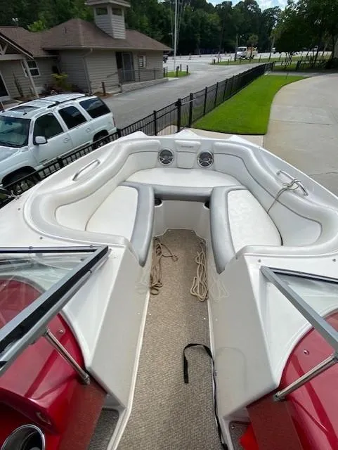 Slide: The Image of 2013 Rinker Captiva 220 MTX boat interior with white seating and red accents. - 6