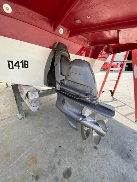 Slide: The Image of 2013 Rinker Captiva 220 MTX boat stern with outboard motor and propeller. - 8