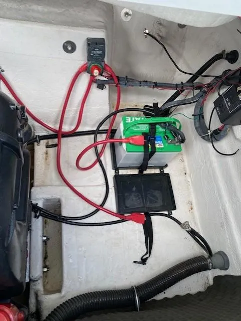 Slide: The Image of 2013 Rinker Captiva 220 MTX boat battery compartment with wiring and components. - 9
