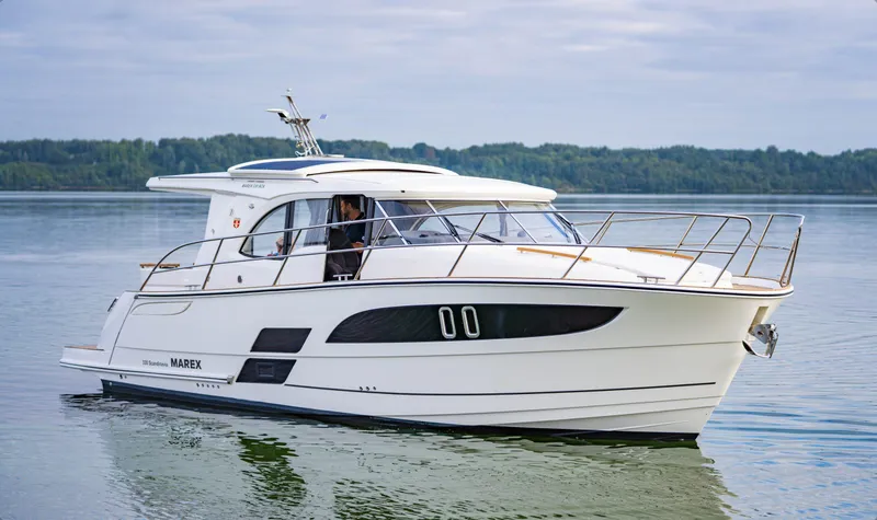 The Image of 2025 Marex 330 Scandinavia yacht cruising on calm waters. - 1