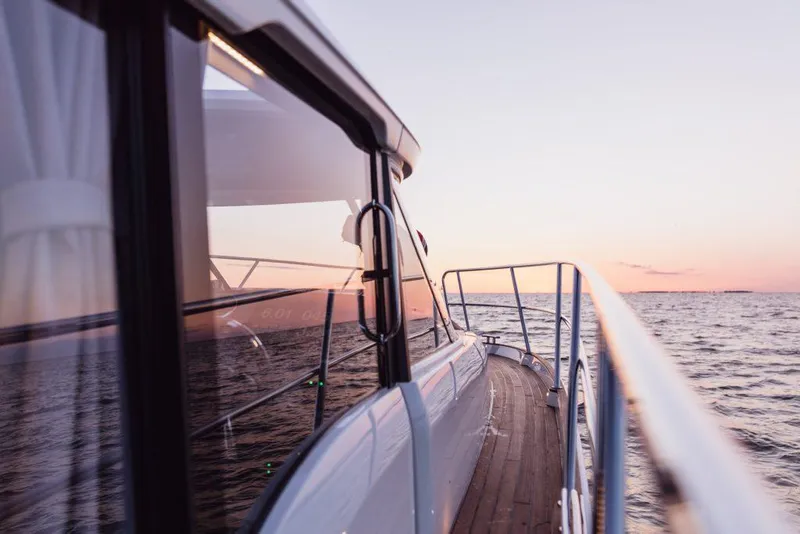 Slide: The Image of 2025 Marex 330 Scandinavia yacht cruising at sunset on calm waters. - 32
