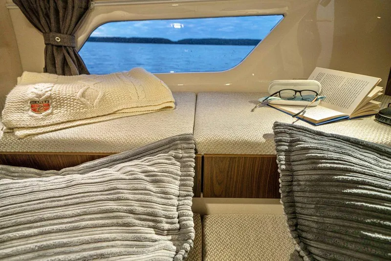 Slide: The Image of Cozy interior of 2025 Marex 330 Scandinavia with cushions, book, and sea view. - 33