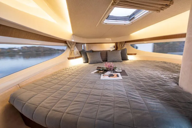 Slide: The Image of Luxurious cabin interior of 2025 Marex 330 Scandinavia yacht with cozy bedding and natural light. - 36