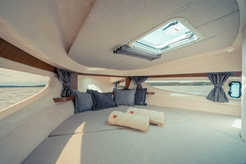 Slide: The Image of Luxurious interior of 2025 Marex 330 Scandinavia yacht with cozy bedding and scenic window views. - 37
