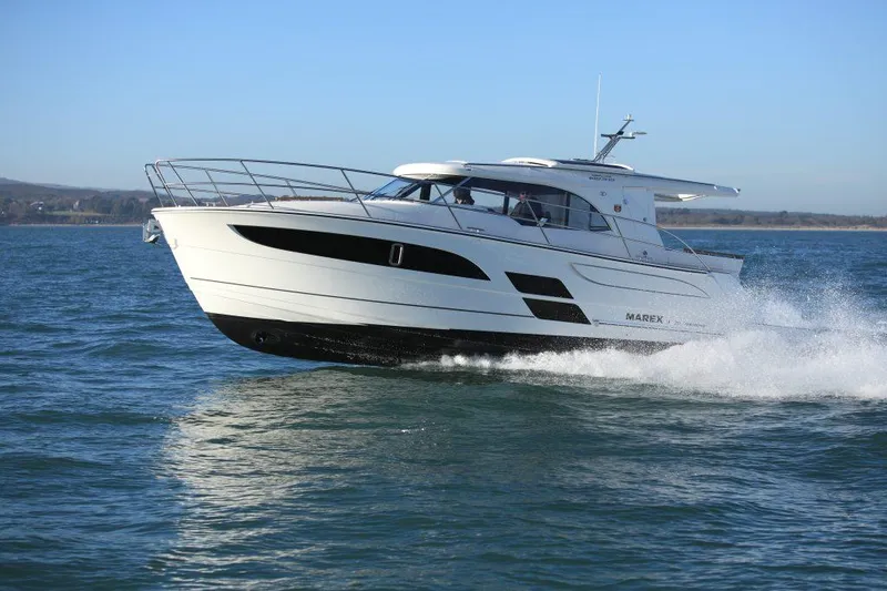 Slide: The Image of 2025 Marex 330 Scandinavia cruising on open water, showcasing sleek design and performance. - 4