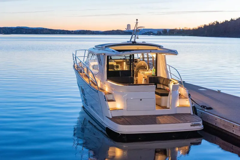 Slide: The Image of 2025 Marex 330 Scandinavia boat docked at sunset on calm water. - 42