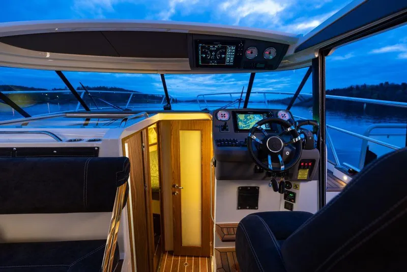 Slide: The Image of Interior view of 2025 Marex 330 Scandinavia boat cockpit at dusk. - 43