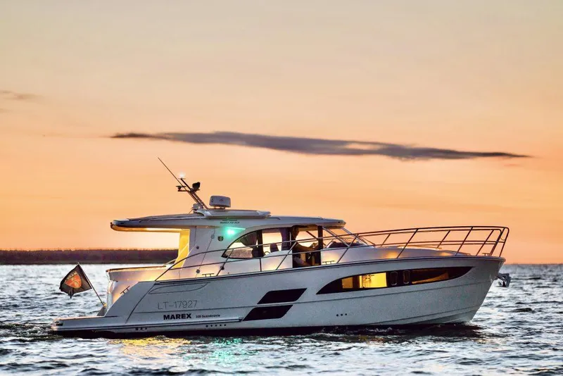 Slide: The Image of 2025 Marex 330 Scandinavia yacht cruising at sunset on calm waters. - 46