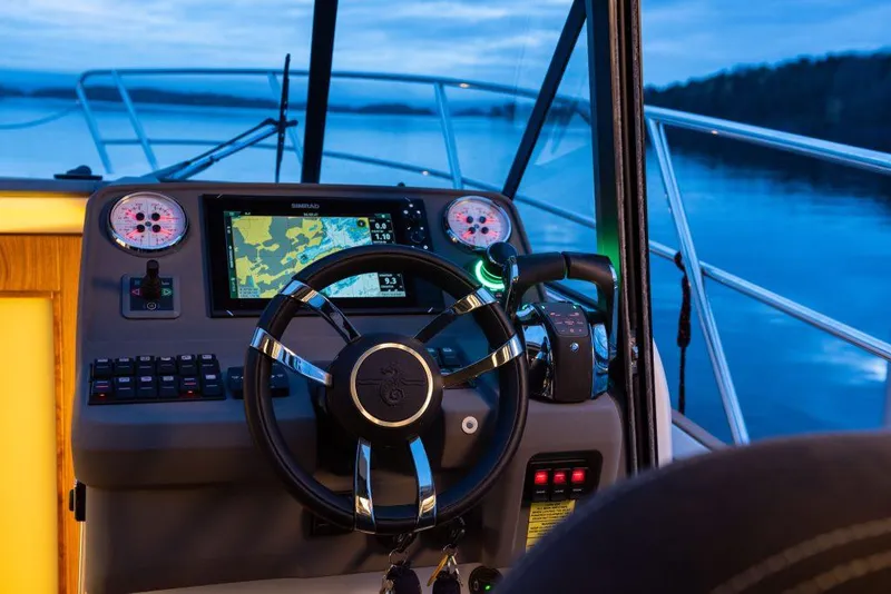 Slide: The Image of Helm of 2025 Marex 330 Scandinavia boat with navigation system at sunset. - 7