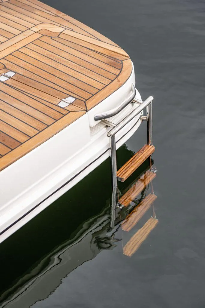 Slide: The Image of 2025 Marex 330 Scandinavia boat with teak deck and swim ladder in water. - 8